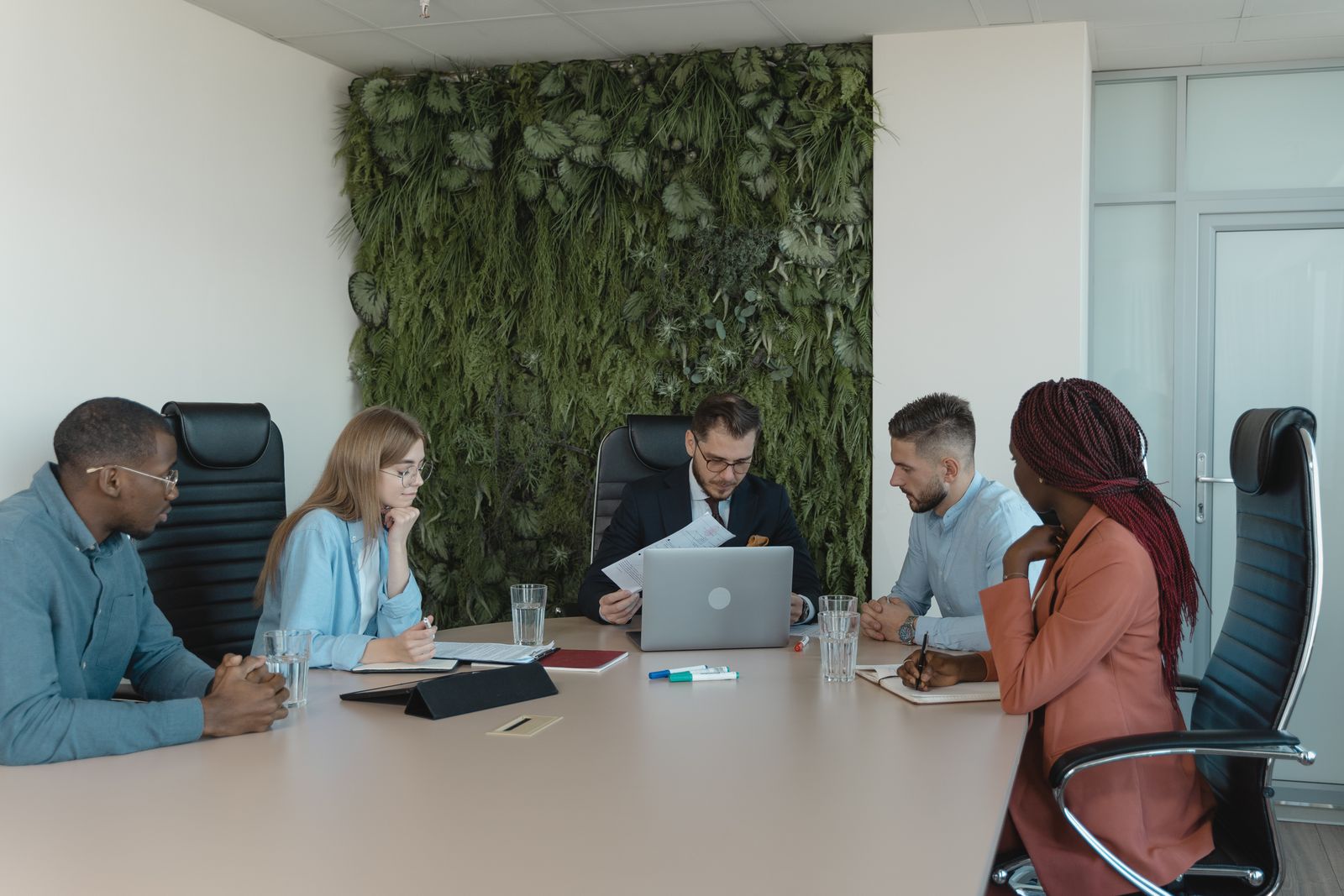 Legal team reviewing a file and collaborating on office work